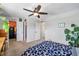 Spacious bedroom features ceiling fan, two closets and neutral carpet at 8666 Mariposa St, Thornton, CO 80260