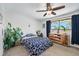 Bedroom with natural light, ceiling fan, plants, and wood furniture at 8666 Mariposa St, Thornton, CO 80260