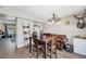Bright dining area with wood table, modern chandelier, and cozy seating, ideal for Gathering gatherings at 8666 Mariposa St, Thornton, CO 80260