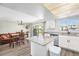 Bright kitchen and dining area with stainless steel appliances, granite countertops, and a modern light fixture at 8666 Mariposa St, Thornton, CO 80260