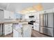 Bright kitchen features stainless steel appliances, granite countertops, and a functional island with seating at 8666 Mariposa St, Thornton, CO 80260