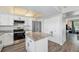 Modern kitchen with stainless steel appliances, granite countertops, and a functional island, perfect for cooking at 8666 Mariposa St, Thornton, CO 80260