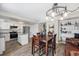 Open-concept kitchen and dining area with modern appliances, granite countertops, and ample cabinet space at 8666 Mariposa St, Thornton, CO 80260