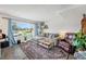 Inviting living room with large window, comfortable gray couch, plants, and colorful rug, creating a cozy atmosphere at 8666 Mariposa St, Thornton, CO 80260
