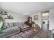 Comfortable living room with plush gray sectional, stylish rug, and curated decor, perfect for relaxation at 8666 Mariposa St, Thornton, CO 80260
