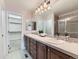 Spacious bathroom with double sinks, updated tile, and a walk-in shower at 7890 S Quatar, Aurora, CO 80016