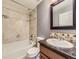 This bathroom features a shower over tub and granite countertop at 7890 S Quatar, Aurora, CO 80016