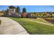 The entrance to the neighborhood features stone walls, mature trees, and a pond at 7890 S Quatar, Aurora, CO 80016