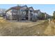 This house features a stone facade, covered porch, and grass lawn at 7890 S Quatar, Aurora, CO 80016