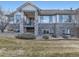 This house features a stone facade, covered porch, and grass lawn at 7890 S Quatar, Aurora, CO 80016