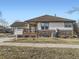 A lovely single story home featuring stone accents, a cozy porch, and well-maintained landscaping at 7890 S Quatar, Aurora, CO 80016