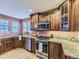 Stylish kitchen boasting stainless steel appliances, wood cabinets, granite countertops, and a hardwood floor at 7890 S Quatar, Aurora, CO 80016