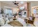 Spacious living room with a cozy fireplace and open layout to the dining area at 7890 S Quatar, Aurora, CO 80016