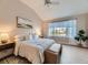 Relaxing main bedroom with a vaulted ceiling, ceiling fan, and a large window at 7890 S Quatar, Aurora, CO 80016