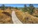 This path is flanked by mature trees, a pond, and a greenbelt at 7890 S Quatar, Aurora, CO 80016