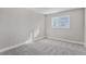 Bright bedroom featuring neutral walls, plush carpet, and a large window with white shutters at 16117 Ledge Rock Dr, Parker, CO 80134