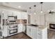 Modern kitchen with white cabinets, granite countertops, stainless steel appliances and hardwood floors at 16117 Ledge Rock Dr, Parker, CO 80134