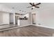 Open-concept living area seamlessly connects to the kitchen, featuring hardwood floors and modern ceiling fan at 16117 Ledge Rock Dr, Parker, CO 80134