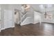 Bright living room with hardwood floors, a staircase and skylight, creating an airy and inviting atmosphere at 16117 Ledge Rock Dr, Parker, CO 80134