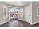 Bright living room with dark hardwood floors, white trim, and sliding doors to the backyard at 16117 Ledge Rock Dr, Parker, CO 80134