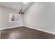 Hardwood floors, neutral walls, and window shutters accent this open area with natural light at 16117 Ledge Rock Dr, Parker, CO 80134