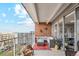 Spacious balcony featuring an outdoor seating area with city views and brick siding at 955 Eudora St # 801E, Denver, CO 80220