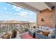 Balcony with an outdoor seating area and railing and city views with brick siding at 955 Eudora St # 801E, Denver, CO 80220