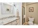 Neutral bathroom featuring a granite countertop, white vanity, and glass shower door at 955 Eudora St # 801E, Denver, CO 80220