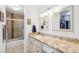 Bright bathroom featuring a granite countertop, white vanity, and a tub and shower at 955 Eudora St # 801E, Denver, CO 80220