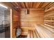 Private sauna room with wood paneling, bench seating, and stone accents at 955 Eudora St # 801E, Denver, CO 80220