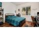 Comfortable bedroom with a large window, bed, and desk with a view at 4085 S Crystal Cir # 104, Aurora, CO 80014