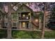 Inviting two-story home with a charming front porch, stone accents, and well-manicured lawn at 4085 S Crystal Cir # 104, Aurora, CO 80014