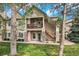 Inviting exterior view showcasing stone accents and a charming second-story balcony at 4085 S Crystal Cir # 104, Aurora, CO 80014