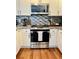 Updated kitchen features a stainless steel oven and sleek backsplash at 4085 S Crystal Cir # 104, Aurora, CO 80014