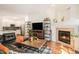 Open living room leading to the kitchen features a fireplace and wood floors at 4085 S Crystal Cir # 104, Aurora, CO 80014