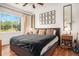 Serene main bedroom with a large window, comfortable bed, and stylish decor at 4085 S Crystal Cir # 104, Aurora, CO 80014