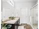 Bathroom with double sinks, a large mirror, and a glass-enclosed shower at 3488 Purcell St, Brighton, CO 80601