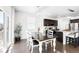 Dining area filled with natural light featuring modern table with chairs and adjacent modern kitchen at 3488 Purcell St, Brighton, CO 80601