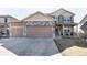 Beautiful home featuring a stone accent wall, a two-car garage and covered porch at 3488 Purcell St, Brighton, CO 80601