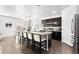 Modern kitchen with seating around a large island and a dining area, perfect for entertaining at 3488 Purcell St, Brighton, CO 80601