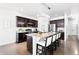 Spacious kitchen with stainless steel appliances, a large island, and modern lighting at 3488 Purcell St, Brighton, CO 80601