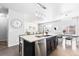 Modern kitchen featuring an island, stainless steel appliances, an adjacent dining and living space at 3488 Purcell St, Brighton, CO 80601