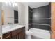 Modern bathroom with sleek vanity, tiled shower and bathtub, and modern fixtures at 4511 Meade St, Denver, CO 80211