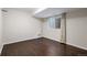 Bedroom with wood flooring, a window with blinds and neutral paint throughout at 4511 Meade St, Denver, CO 80211