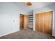 Bedroom features brown carpet, access to a walk-in closet and colorful built-in shelving at 4511 Meade St, Denver, CO 80211