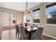 Dining room featuring hardwood floors, modern light fixture, and access to the outdoor patio at 4511 Meade St, Denver, CO 80211