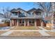 Charming two-story home featuring stone accents, a well-maintained lawn, and a welcoming front entrance at 4511 Meade St, Denver, CO 80211