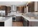 Modern kitchen featuring stainless steel appliances, a center island, sleek countertops, and contemporary cabinetry at 4511 Meade St, Denver, CO 80211