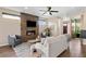 Inviting living room with a stone fireplace, hardwood floors, and large windows for ample natural light at 4511 Meade St, Denver, CO 80211