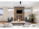 Inviting living room with a stone fireplace, hardwood floors, and large windows for ample natural light at 4511 Meade St, Denver, CO 80211